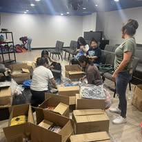 Volunteers sorting and packing boxes of donations